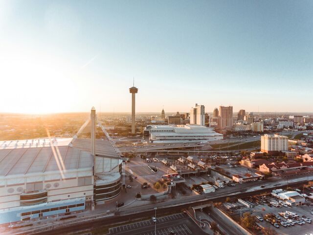 Aerial view of the Alamodome and Tower of the Americas at sunset