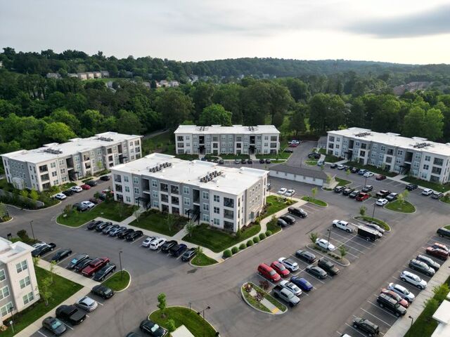 Aerial view of garden apartment buildings and surface parking