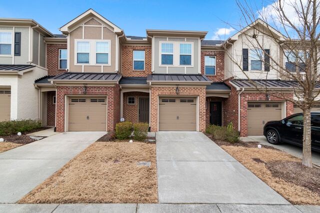 Brick townhomes with attached garages and private driveways
