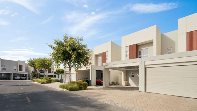 Row of modern homes with attached garages and covered parking