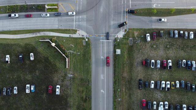 Aerial view of a suburban crossroads and parking areas