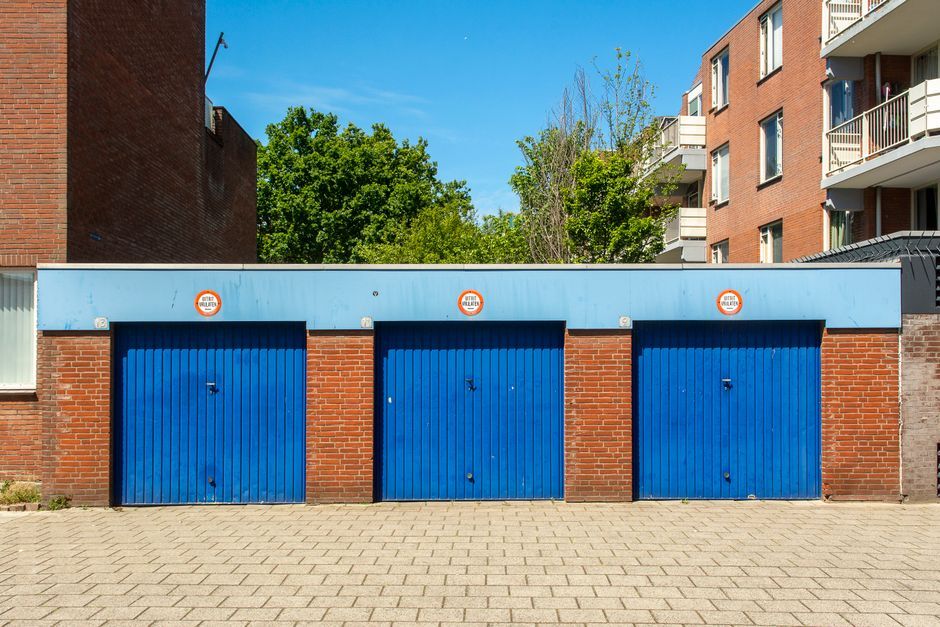 Detached garage doors beside an apartment building