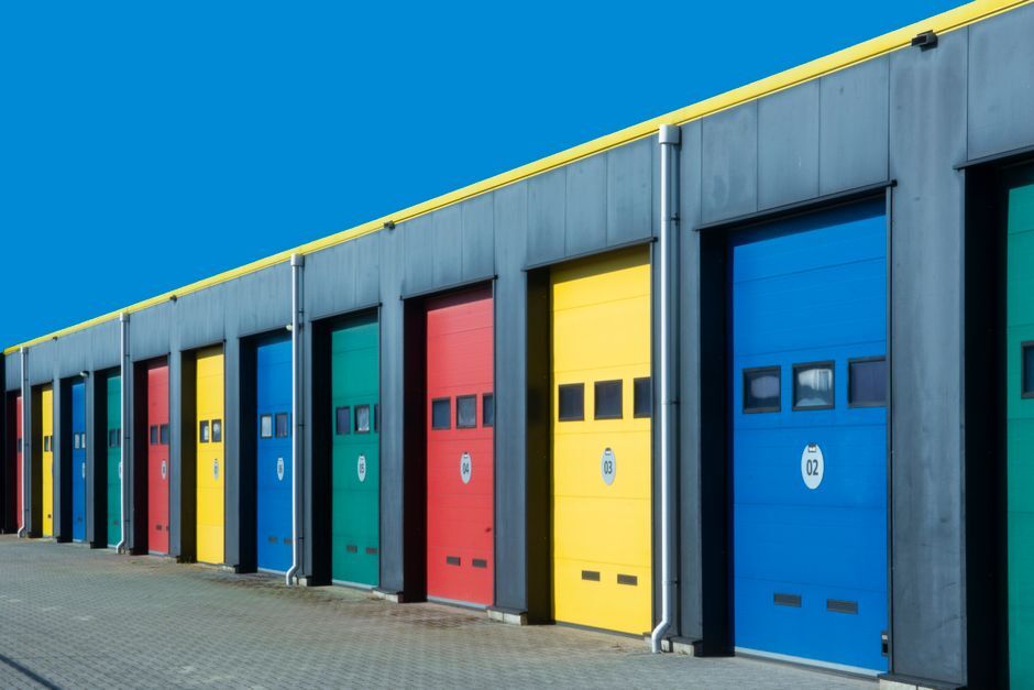 Row of large roller doors on a commercial building