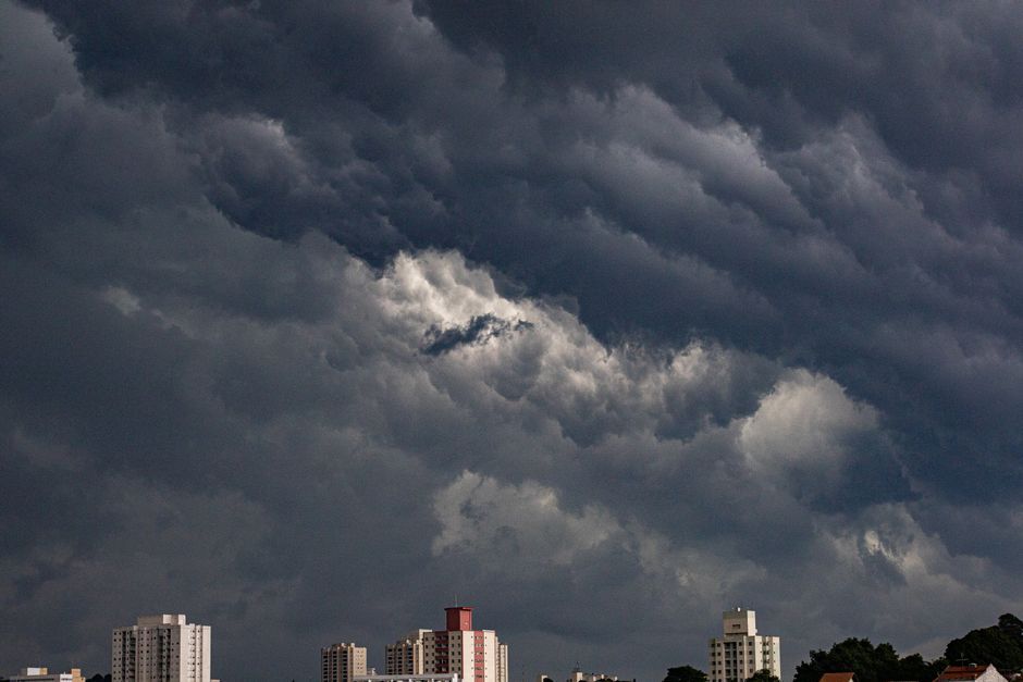 Dark storm clouds gathering over rooftops