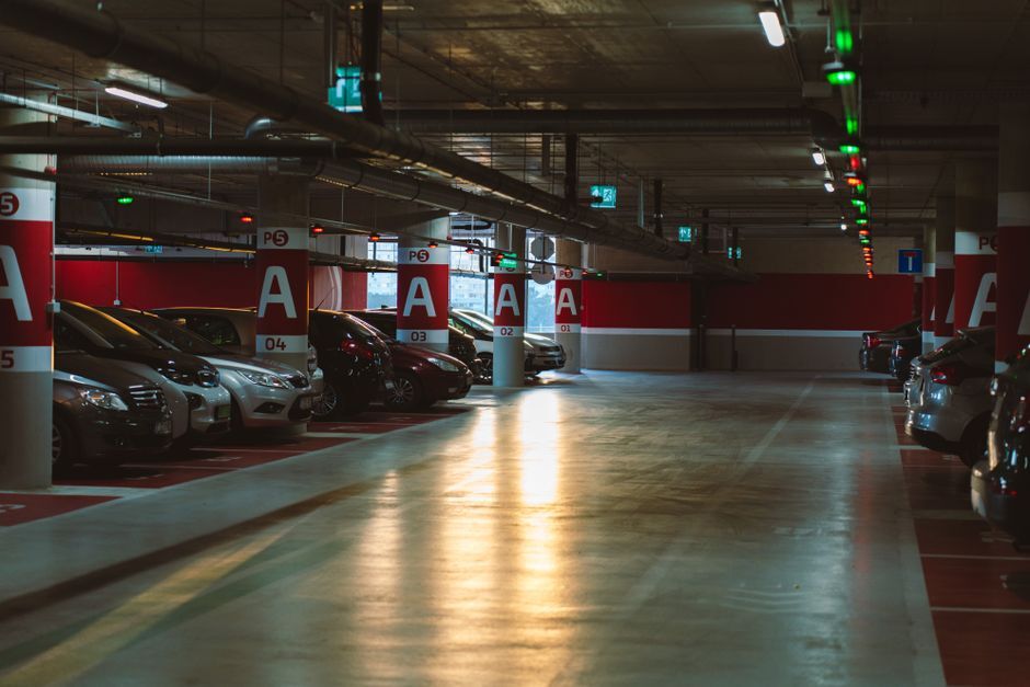 Cars parked inside a lit structured parking garage