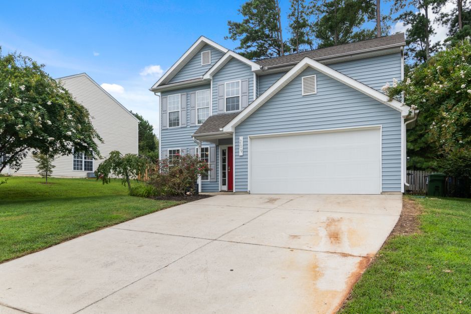 Two-story house with a wide driveway and attached garage