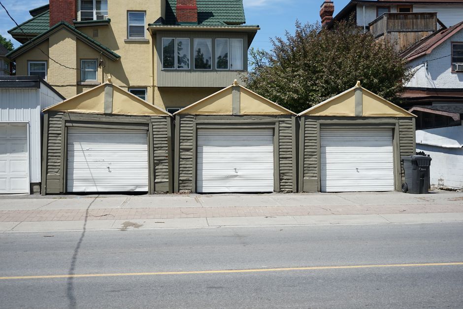 Detached garages behind older houses on a residential street